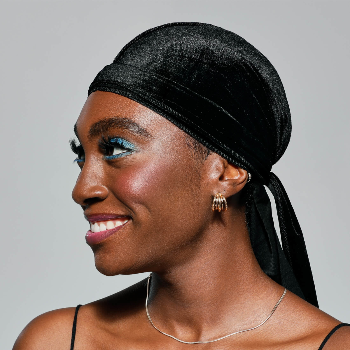 A woman modeling the Bow Wow KISS Colors &amp;amp; Care Power Wave Luxe Velvet Durag in black. 